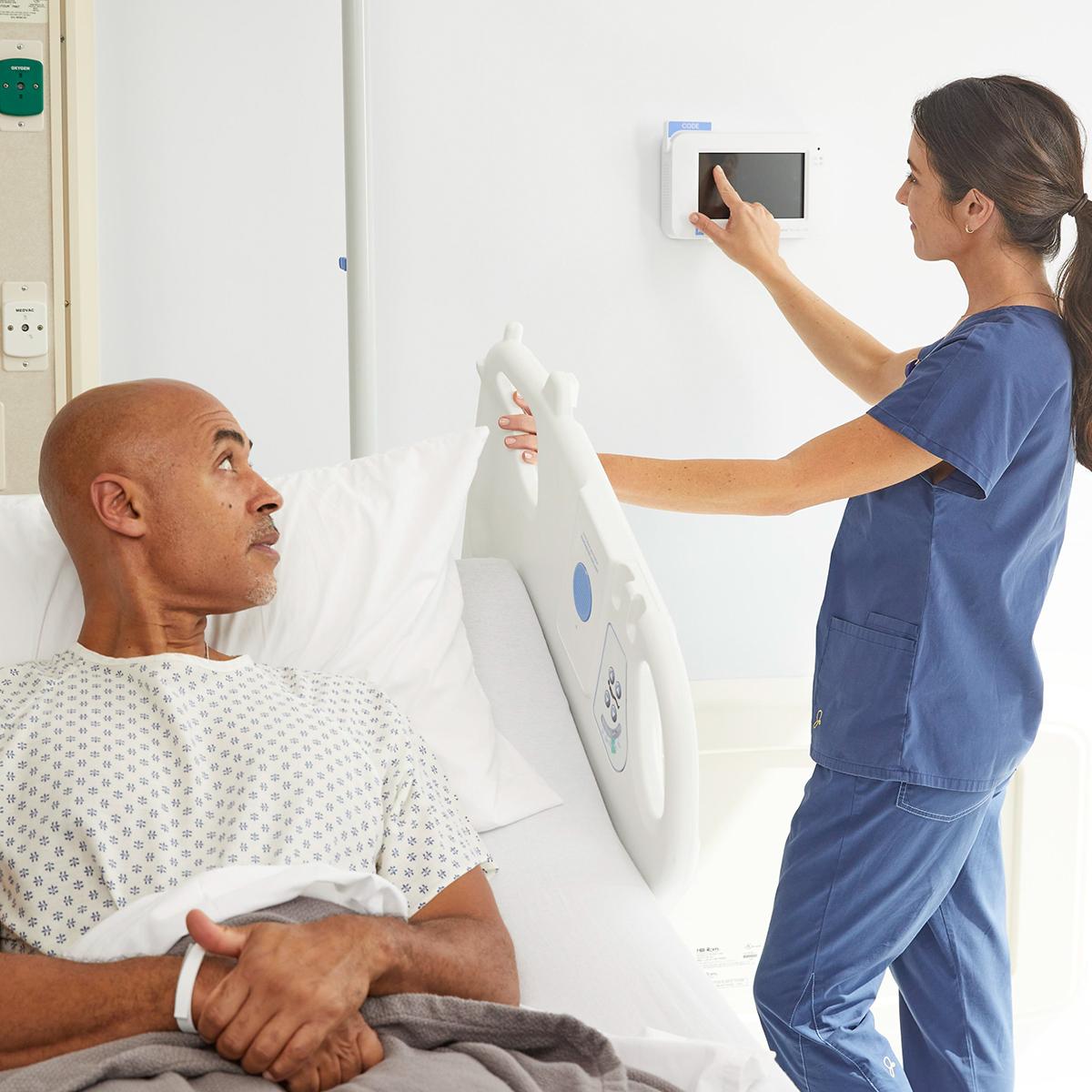 Nurse using the Voalte Nurse Call Patient Station in the patient room