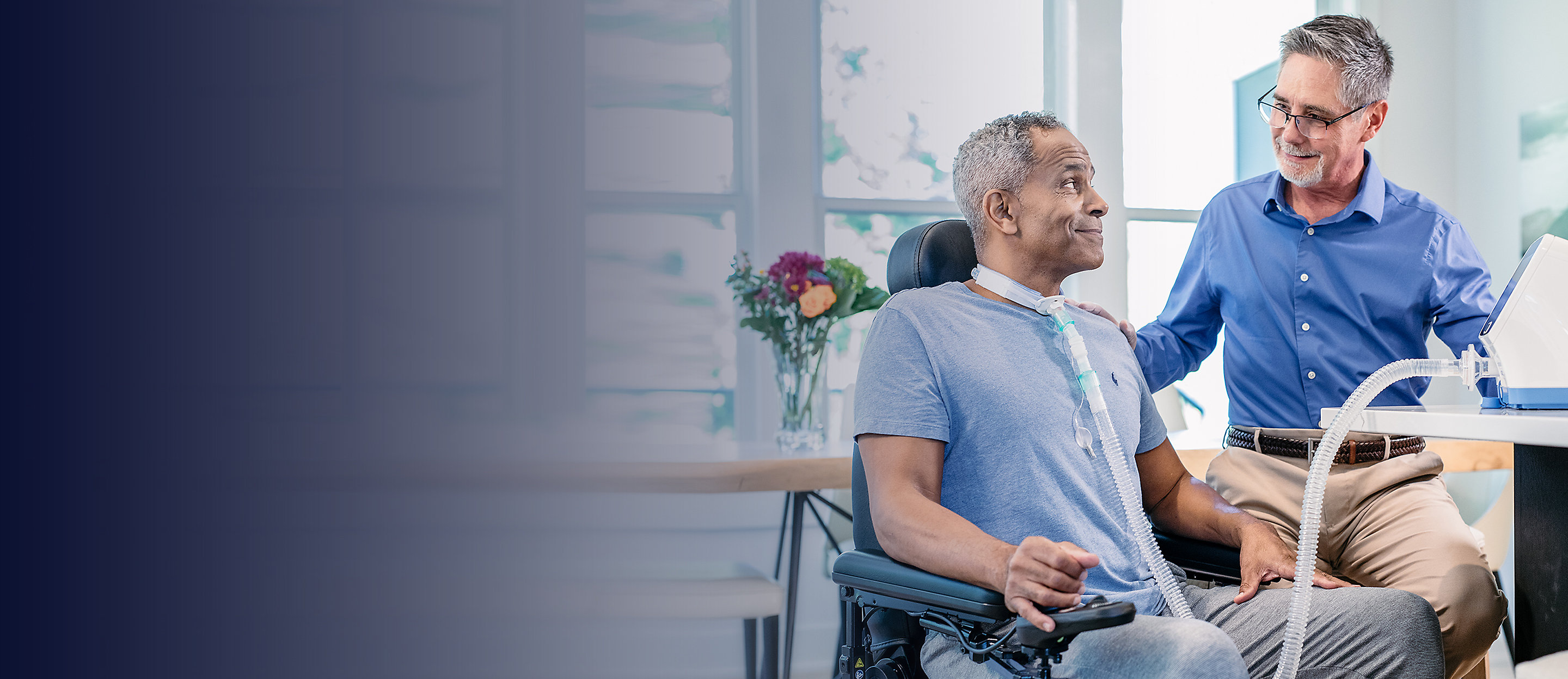 A patient in a wheelchair with a tracheostomy uses the Volara System OLE Therapy in the comfort of his home