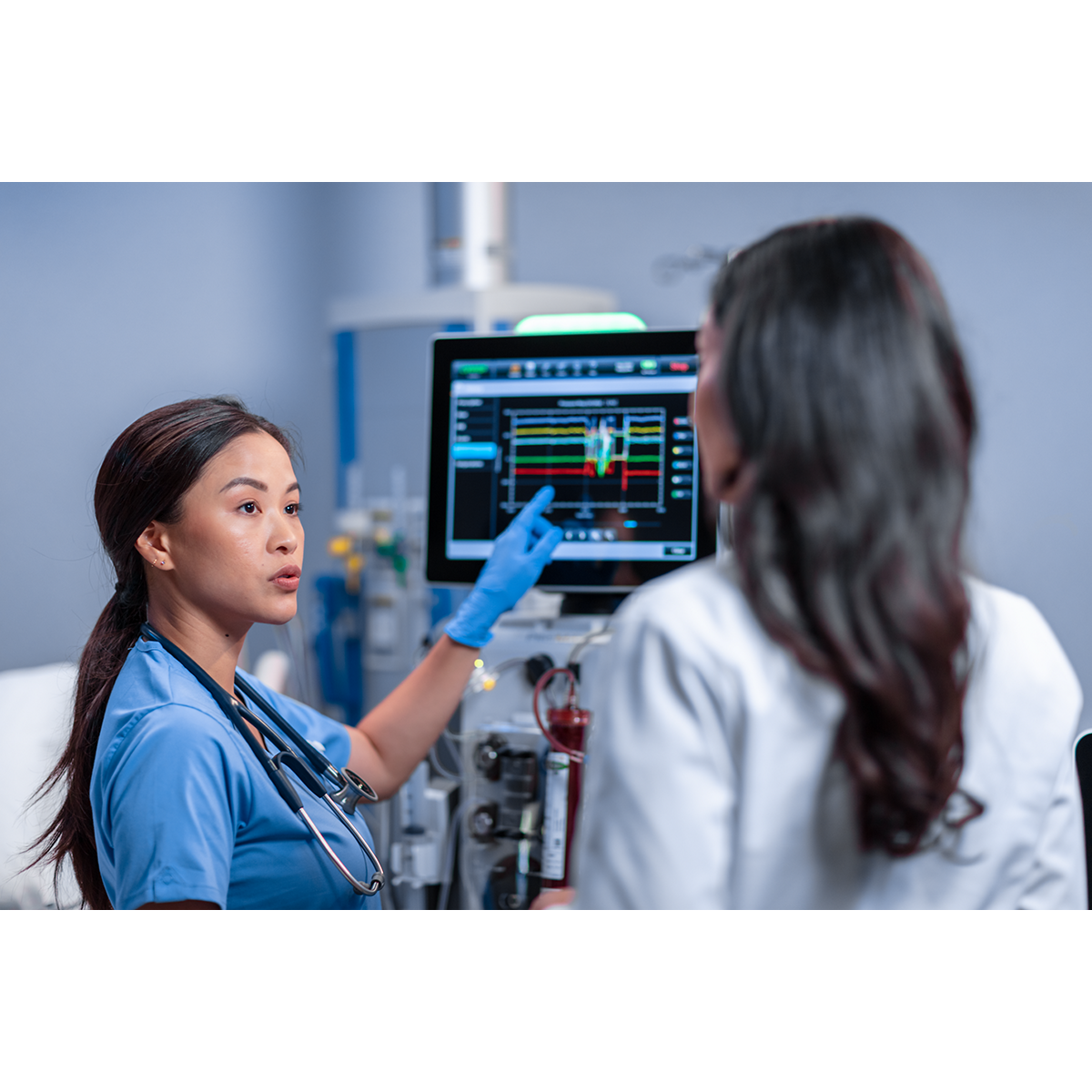 healthcare workers look at screen monitor together