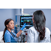 healthcare workers look at screen monitor together