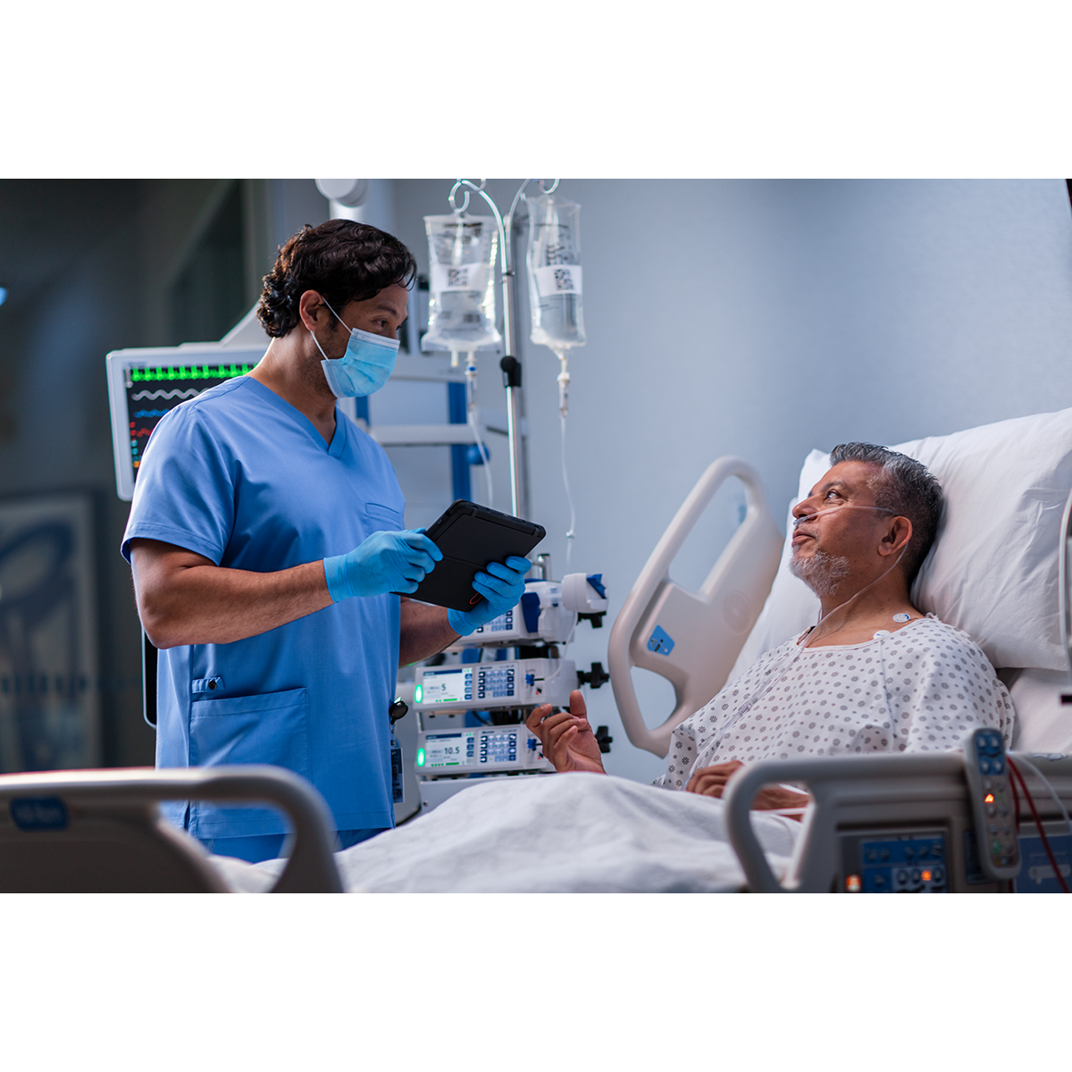 Clinician speaks with patient holding tablet